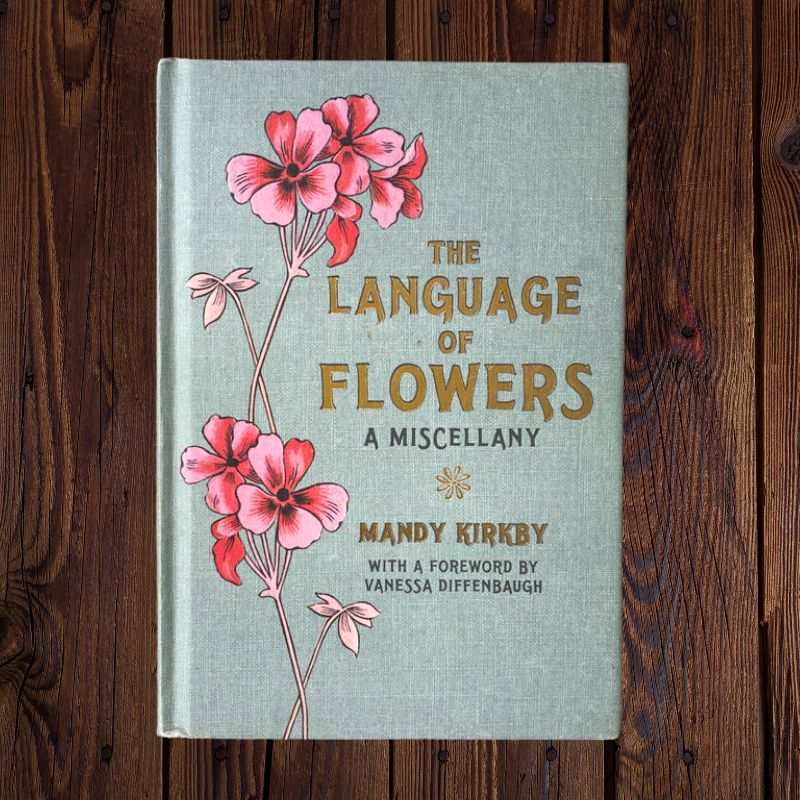 Photo of the book 'The Language of Wildflowers - a Miscellany' by Mandy Kirby - grey fabric cover with pink flowers