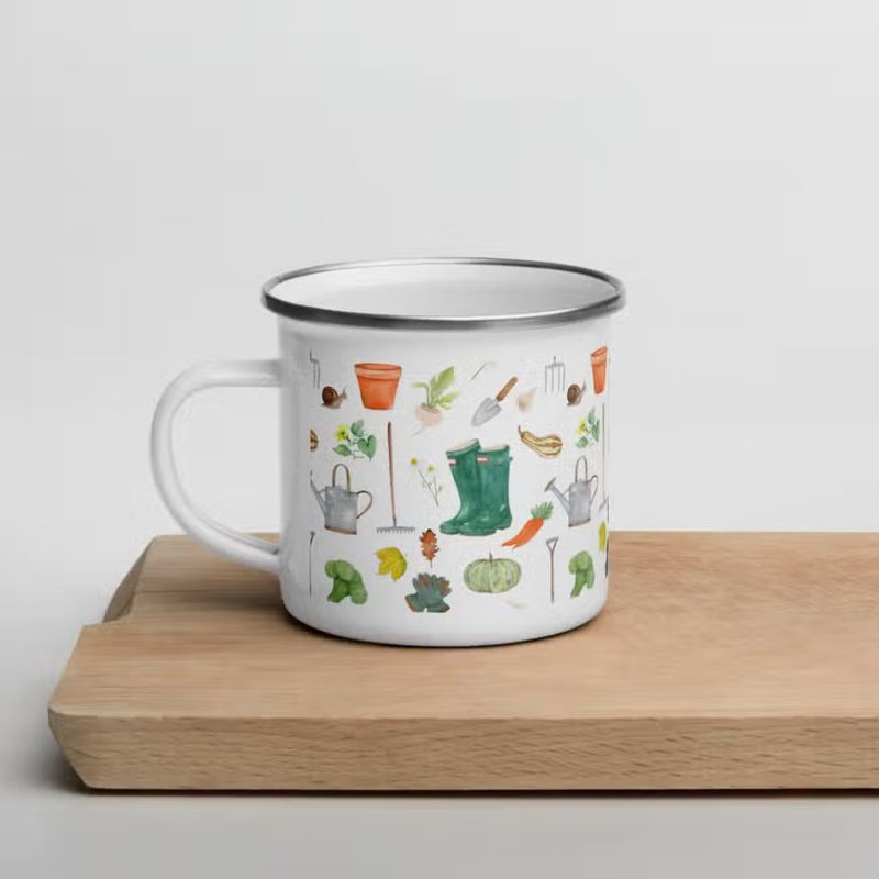 An enamel mug with watercolour-style gardening motifs