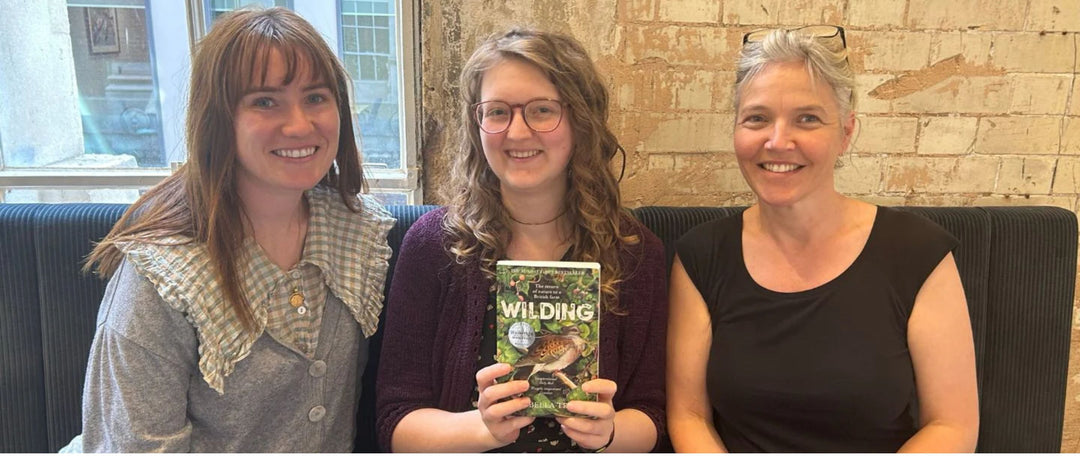 The Meadowmania team and a copy of Wilding by Isabella Tree